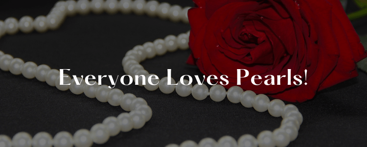 everyone loves pearls string of beautiful pure white pearls beside a red rose
