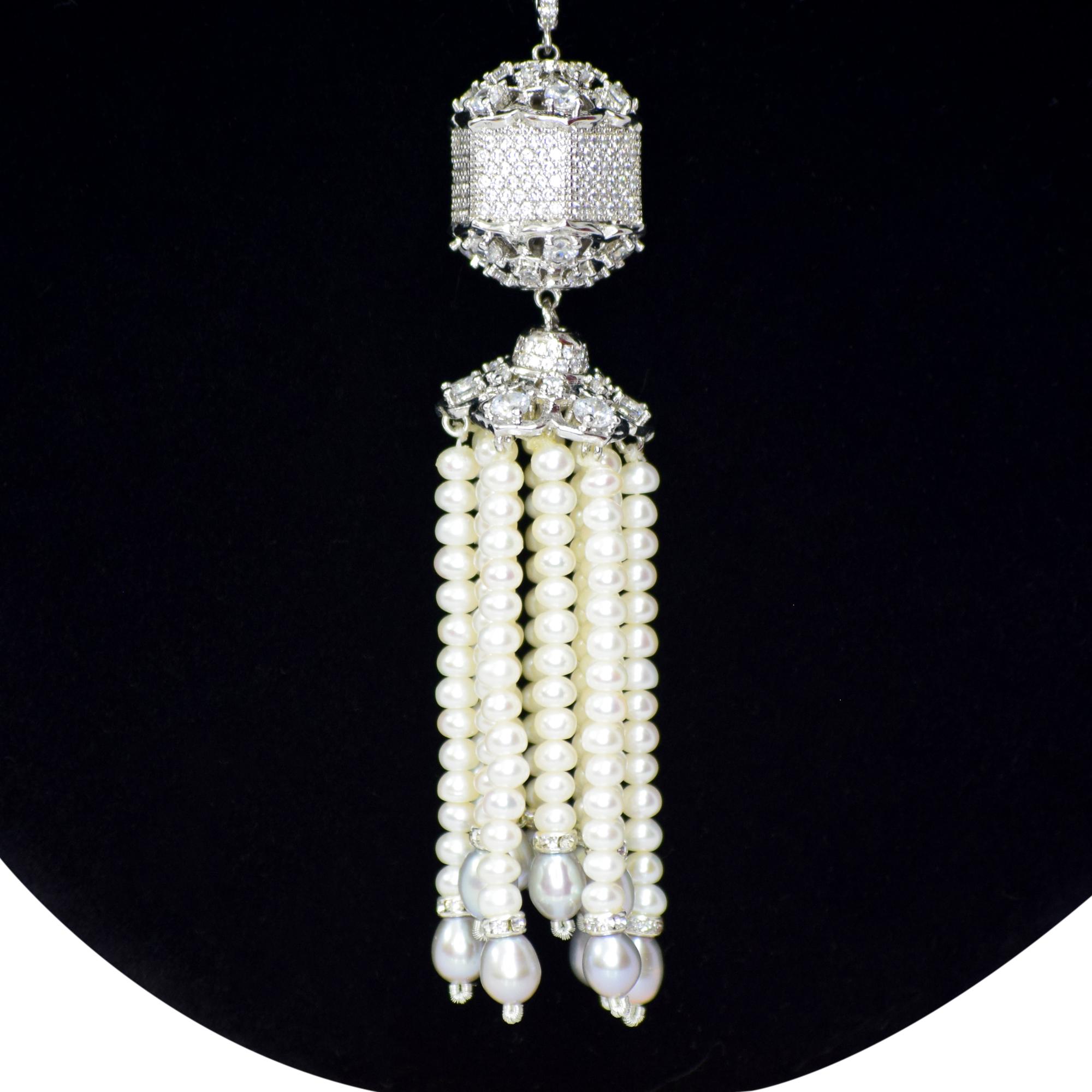 White pearls necklace featuring a very cute silver droplet studded with zircons and pearl hangings close up