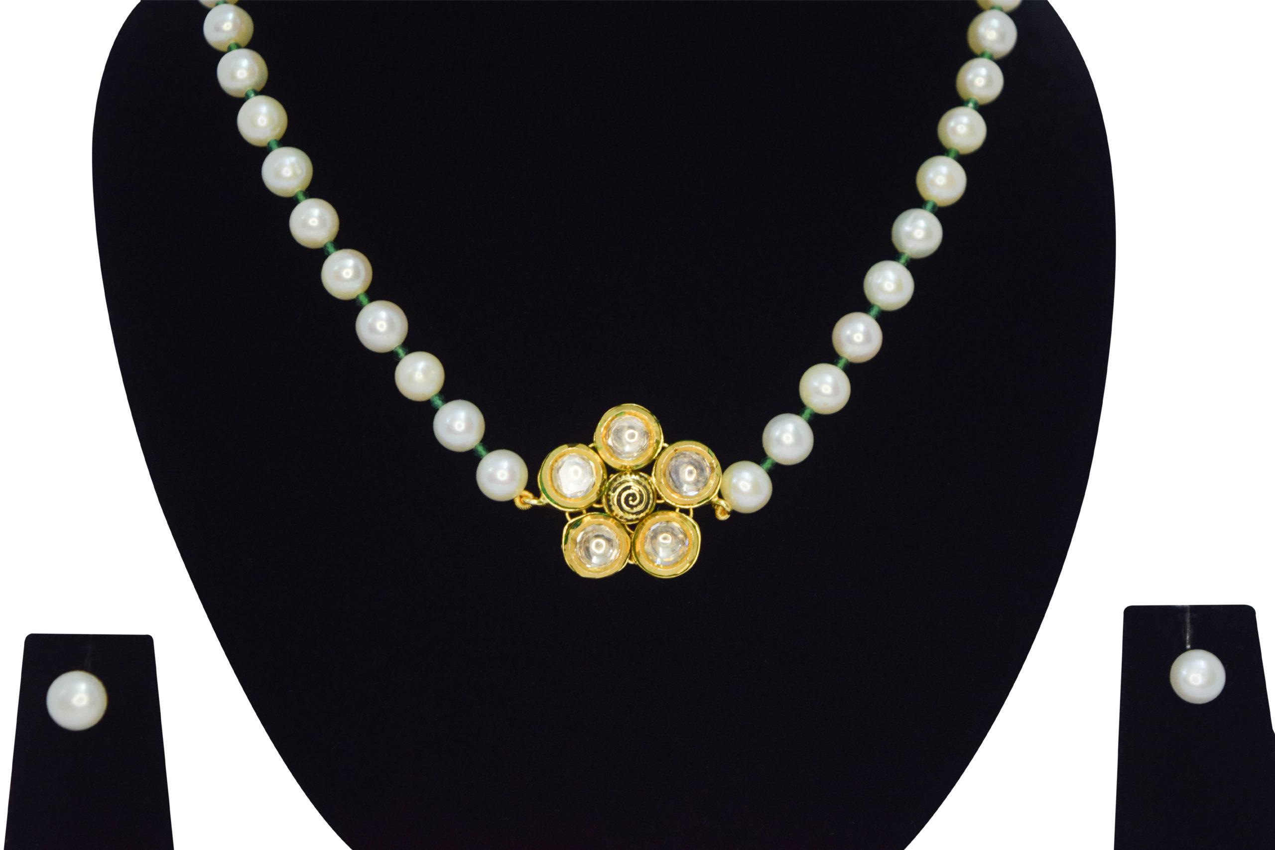 Well crafted single row round white pearl necklace with emerald cz crystals & a floral kundan pendant - close up