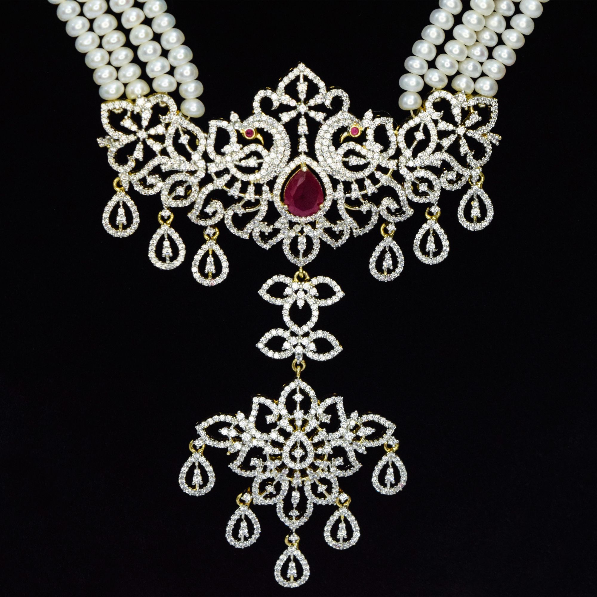 Multi-layer 5mm white semi-round pearl necklace with a majestic zircon studded peacock pendant featuring an SP ruby - close up