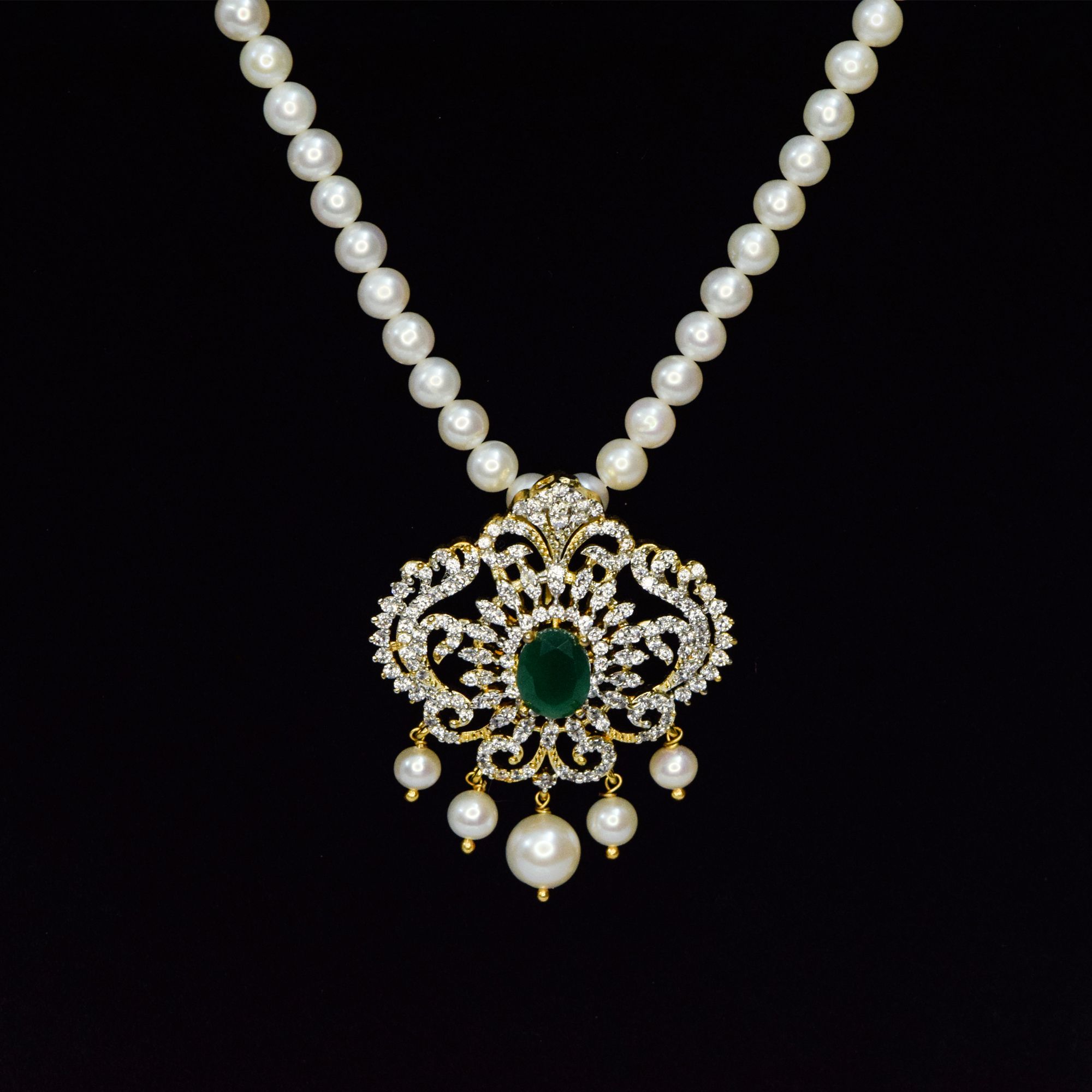 Bright 5mm round white pearls necklace with an artistic CZ studded peacock pendant with SP Emerald in the centre - close up