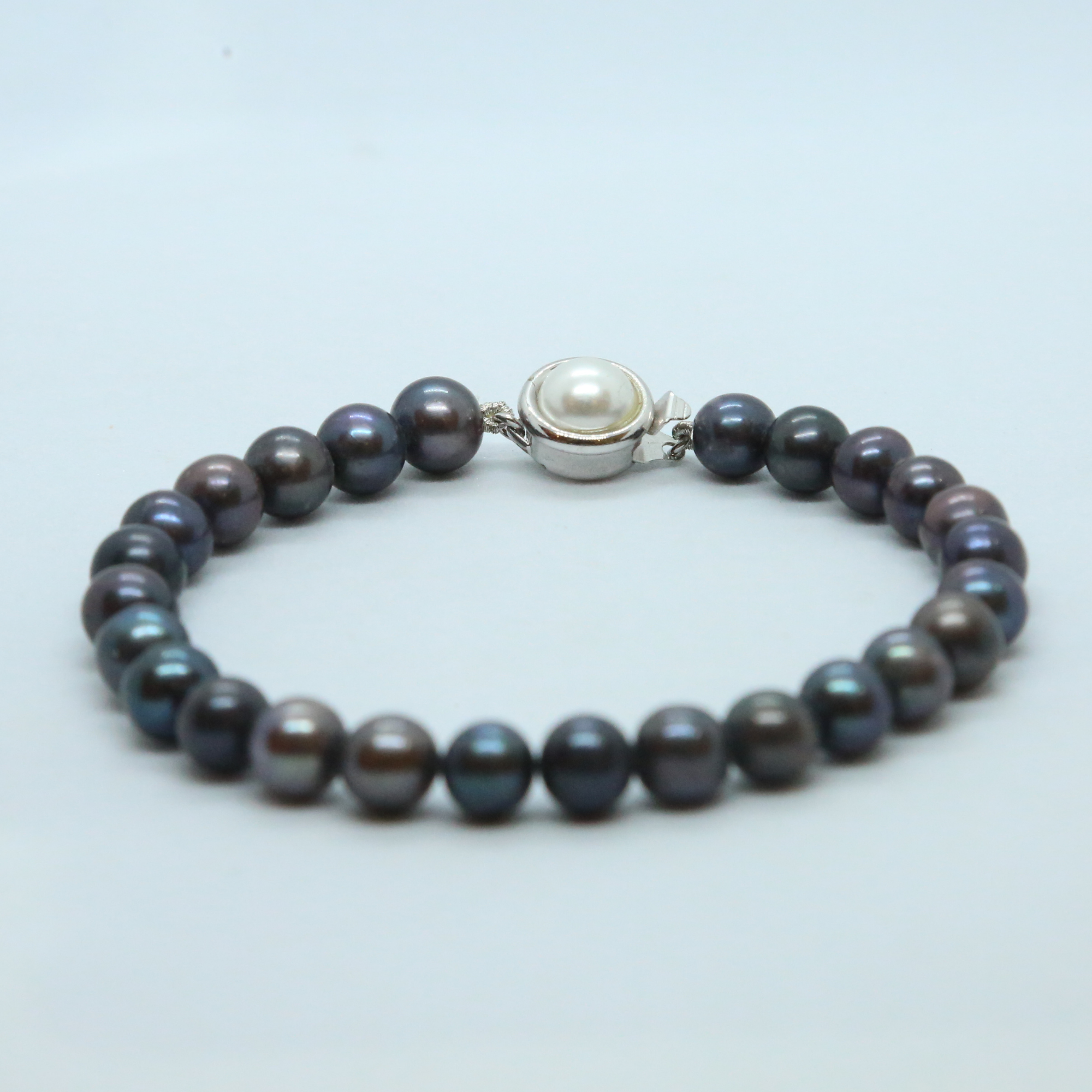 Glorious Multi-shaded 7.5mm Round Pearls Bracelet-clasp