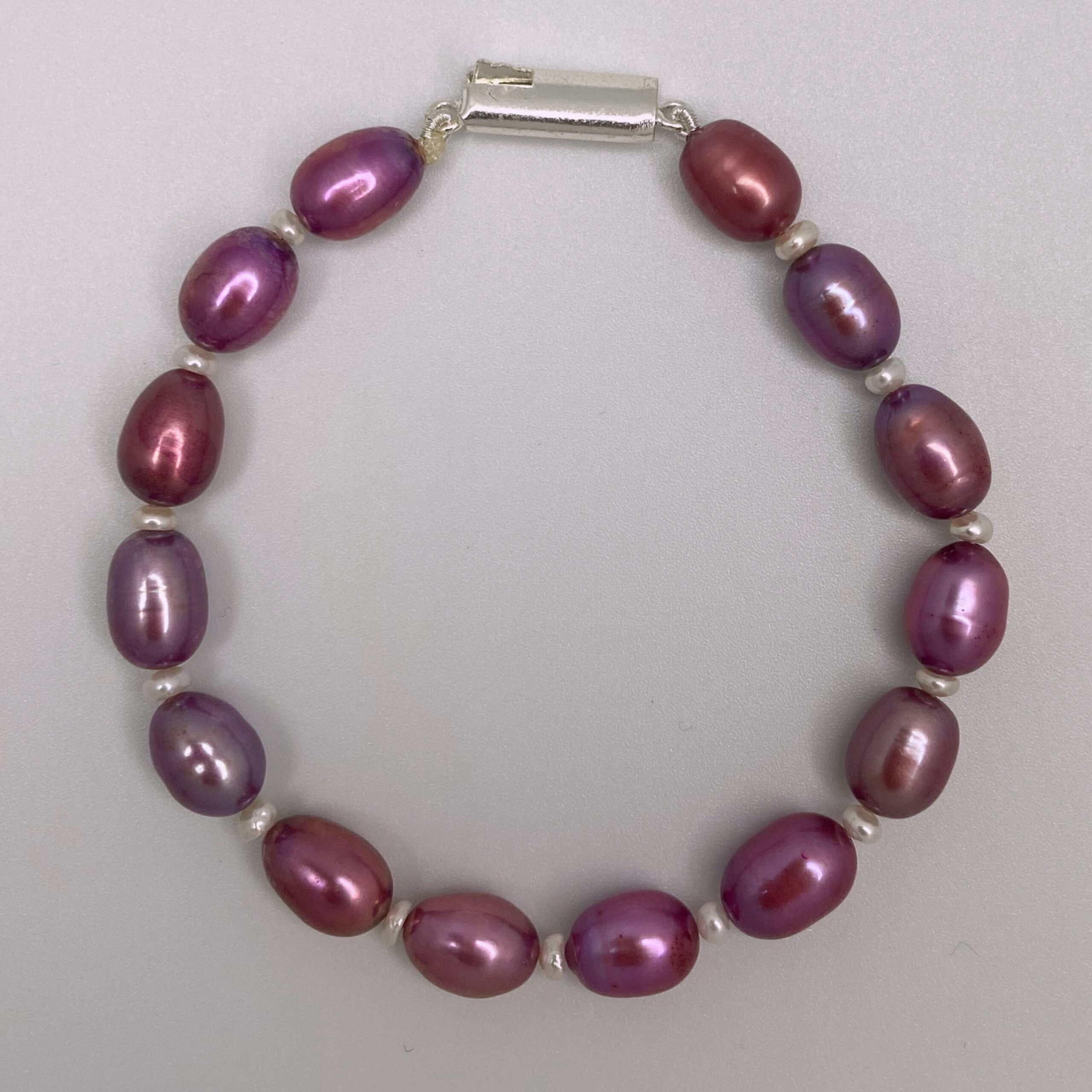 Ravishing Magenta Oval Pearls Bracelet With White Seed Pearls-top